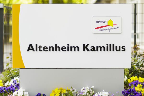 Eingangsschild Altenheim Kamillus mit Stiefmütterchen umrandet